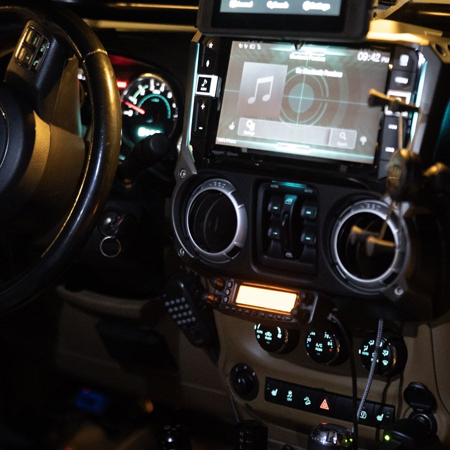 Cabin close-up with Alpine screen, radio, and twin-stick shifters